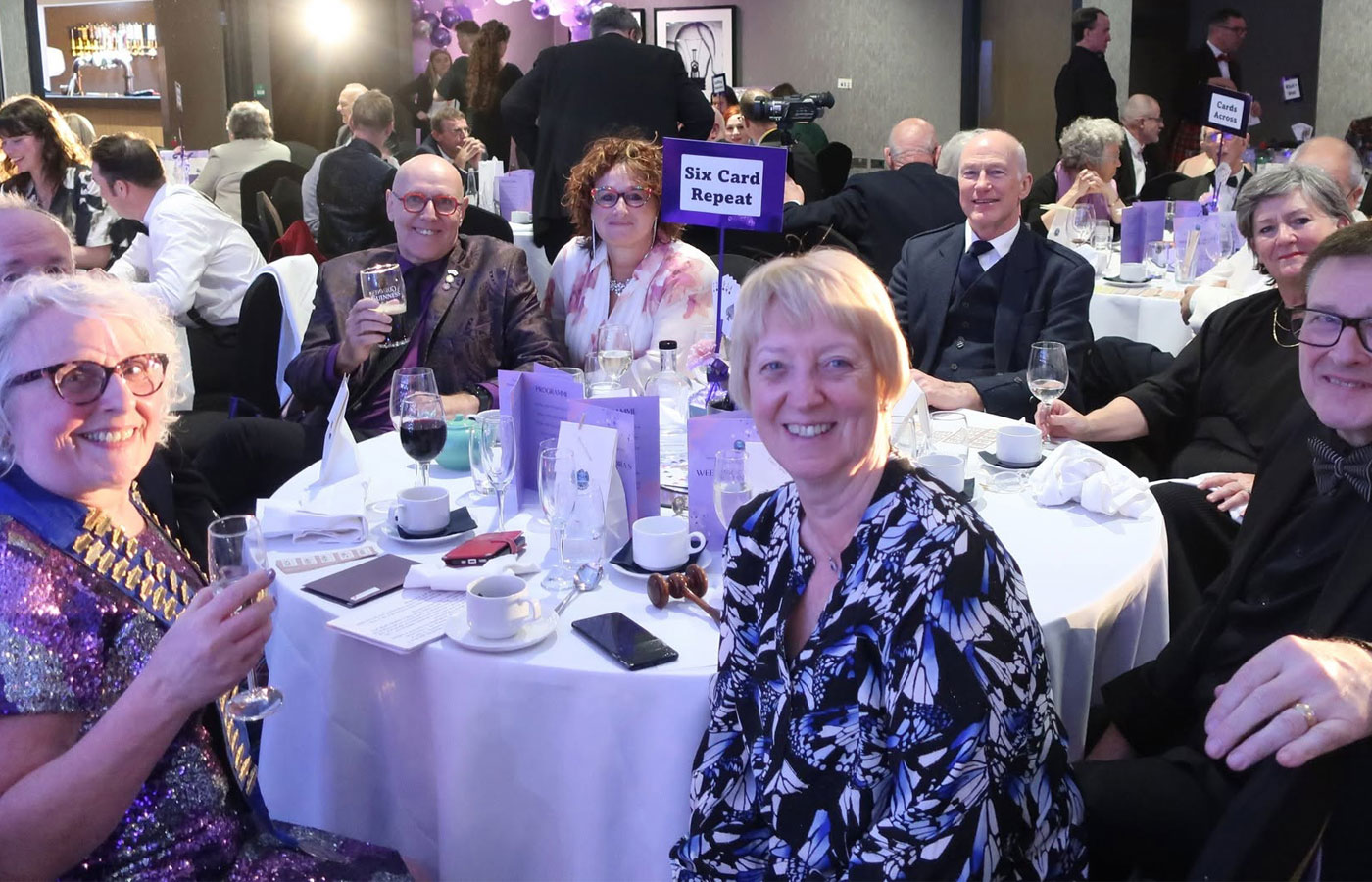 Members and guests gathered around a dinner table